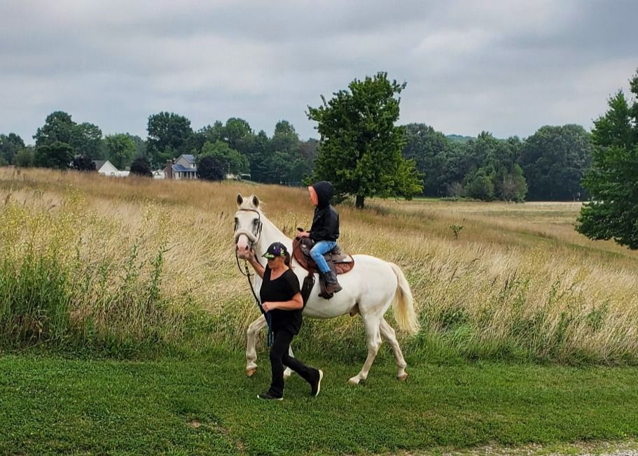 Rider on horseback on the grounds at Solid Rock Redemption Center